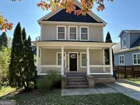 Two-story house with beige siding, a porch, and brick steps at 150 Turman Se Ave, Atlanta, GA 30315