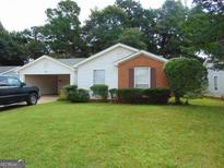 Charming ranch home with brick and vinyl siding, and a well-maintained lawn at 148 Lake Ter, Mcdonough, GA 30253