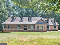 Brick house with a wraparound porch and large yard at 95 Fern Ct, Stockbridge, GA 30281