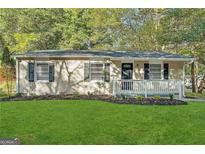 Brick ranch home with a newly landscaped yard and white railing at 362 Ard Nw Pl, Atlanta, GA 30331