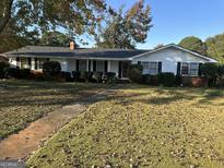 Ranch house with brick facade and mature landscaping at 4634 Bexley Dr, Stone Mountain, GA 30083