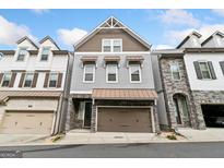 Modern three-story townhome with stone accents at 1145 Kirkland Se Cir, Smyrna, GA 30080