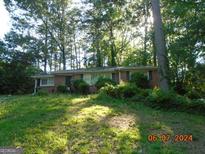 Brick ranch house with mature trees and landscaping at 2555 Graywall St, Atlanta, GA 30344