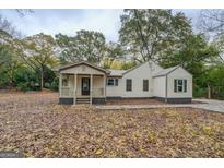 Charming craftsman style home with a covered porch and landscaped yard at 5122 Hillcrest Nw Dr, Covington, GA 30014