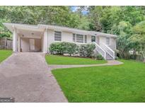 Ranch home with attached carport and landscaped yard at 2425 Hanford Sw Dr, Atlanta, GA 30315