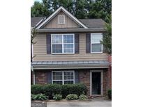 Two-story townhome with stone accents and landscaping at 2628 Haligan Pointe, Riverdale, GA 30296