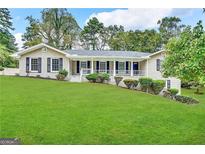 Ranch home with covered porch and landscaping at 1904 Caribaea Se Trl, Atlanta, GA 30316
