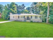 Charming ranch house with a well-maintained lawn at 1581 Hollyhock Ter, Decatur, GA 30032