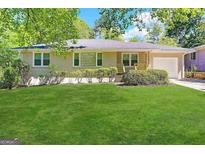 Charming ranch home with a well-manicured lawn at 4778 Glenwood Rd, Decatur, GA 30035