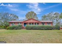 Brick ranch house with landscaped yard and spacious lawn at 115 Bernhard Rd, Fayetteville, GA 30215