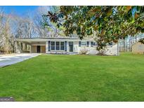 Charming ranch home with a lush green lawn at 3850 Bright Star Rd, Douglasville, GA 30135