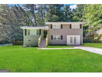 Newly renovated ranch home with gray exterior and attached garage at 4310 Bakers Ferry Sw Rd, Atlanta, GA 30331