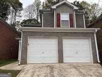 Two-car garage and brick front elevation at 208 Rankin Cir, Mcdonough, GA 30253