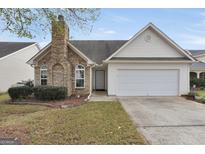 House exterior with stone accents and a two-car garage at 1120 Strath Clyde Way, Mcdonough, GA 30253