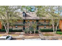 Two-story building exterior with multiple units, landscaping, and fountain at 312 Brittany Ct, Duluth, GA 30096