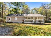 Quaint single-story home with front porch and lush lawn at 465 Haynie Rd, Moreland, GA 30259