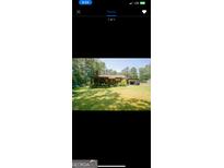 Ranch home with a spacious backyard, covered patio, and detached carport at 5206 Warner St, Morrow, GA 30260