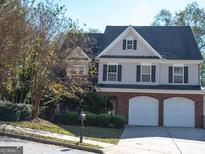 Two-story brick home with a three-car garage at 3700 Newhalem Sw St, Atlanta, GA 30331