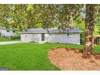 Charming ranch home with gray siding and green lawn at 1919 Glenmar Dr, Decatur, GA 30032