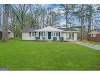 Ranch style home with a spacious lawn and covered porch at 4433 Mercer Rd, Decatur, GA 30035