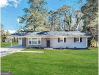Charming ranch home with a well-maintained lawn at 3691 Fred Walker Sw Dr, Smyrna, GA 30082