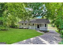 Ranch home with white porch and driveway at 2370 Tiffany Cir, Decatur, GA 30035