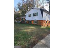 Ranch style home with green shutters and a large yard at 1521 Green Valley Ct, Conley, GA 30288