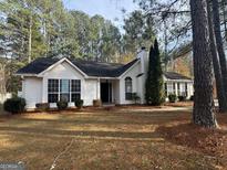 Charming single-story home with a landscaped front yard and trees at 116 Winthrop Dr, Sharpsburg, GA 30277