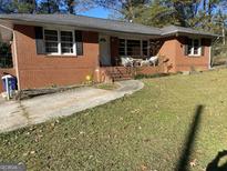 Brick ranch house with a large yard and driveway at 8965 Campbellton St, Douglasville, GA 30134