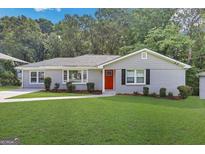 Charming ranch home with gray siding, red door, and well-manicured lawn at 2658 Rollingwood Se Ln, Atlanta, GA 30316
