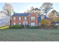 Brick house with two-car garage and well maintained lawn at 2210 Surrey Trl, Atlanta, GA 30349