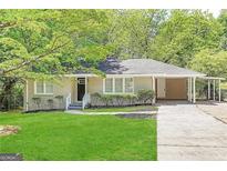 Newly renovated ranch home with carport and well-manicured lawn at 1737 Mckenzie Dr, Decatur, GA 30032