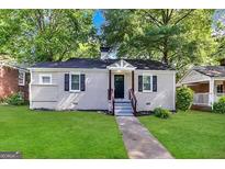 Charming ranch home with freshly painted exterior and manicured lawn at 1327 Sharon Nw St, Atlanta, GA 30314