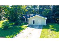 Ranch home with detached garage and spacious yard at 8846 Wesley Pl, Jonesboro, GA 30238