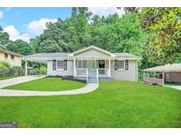 Newly renovated ranch home with a charming front porch and landscaped yard at 220 Oakcliff Nw Ct, Atlanta, GA 30331