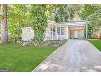 Charming ranch home with a landscaped lawn and driveway at 3010 Pasadena Dr, Decatur, GA 30032