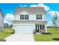 Two-story house with white siding, gray roof, and a two-car garage at 137 Avondale Blvd, Conyers, GA 30013