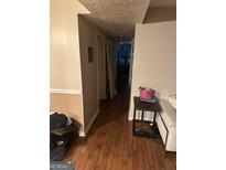 A long hallway with wood floors and access to other rooms at 6390 Magnolia Ln, Morrow, GA 30260