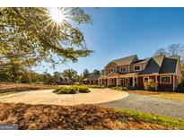 Two-story home with circular driveway and landscaping at 242 Kirkley Rd, Tyrone, GA 30290