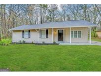 Ranch home with newly landscaped lawn at 4864 Brookstone Pkwy, Ellenwood, GA 30294
