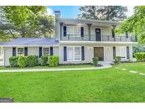 Two-story house with a balcony, freshly painted, and a well-maintained lawn at 2252 Wellington Hills Way, Snellville, GA 30039