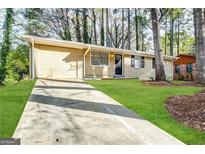 Brick ranch home with a long driveway and a spacious yard at 4448 Malibu Dr, Decatur, GA 30035