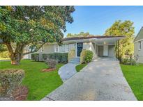 Newly renovated ranch home with a carport and well-manicured lawn at 239 Silver Springs Sw Cir, Atlanta, GA 30310