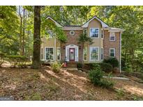 Two-story brick home with large windows and a tree-lined yard at 119 Castlewood Rd, Tyrone, GA 30290