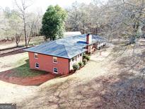 Ranch home with large backyard and detached garage, nestled in a wooded area at 2193 Hiram Douglasville Hwy, Hiram, GA 30141