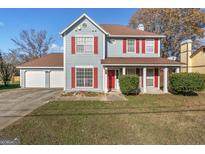 Two-story house with attached garage and red accents at 453 Camp Hill Ln, Jonesboro, GA 30238