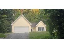 Ranch style home with attached garage, set back from the road with a grassy yard at 221 Lakeview Dr, Stockbridge, GA 30281