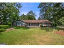 Ranch style home with brick exterior and spacious lawn at 3319 Colony Se Dr, Conyers, GA 30013