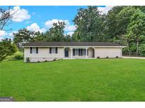 Ranch style home with brick facade, and spacious lawn at 4395 Stonewall Tell Rd, College Park, GA 30349