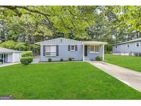 Ranch style home with gray exterior, landscaped lawn, and driveway at 795 Nw Amber Nw Pl, Atlanta, GA 30331
